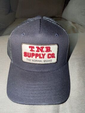 The Normal Brand Navy Trucker Hat with Red Patch